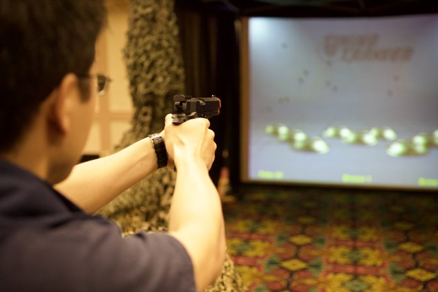 Man with Gun in Front of Screen