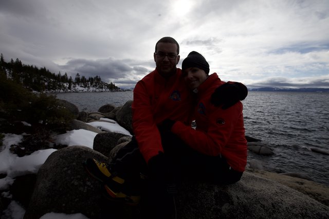 Couple Embracing by Snowy Lake Tahoe Shore