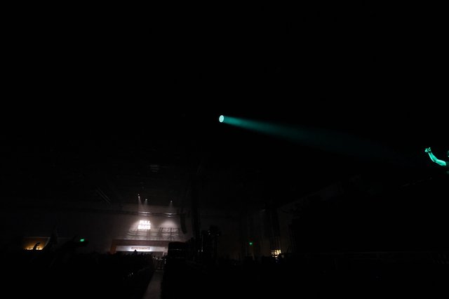 Cyan Laser Beam Cuts Through Dark Festival Night