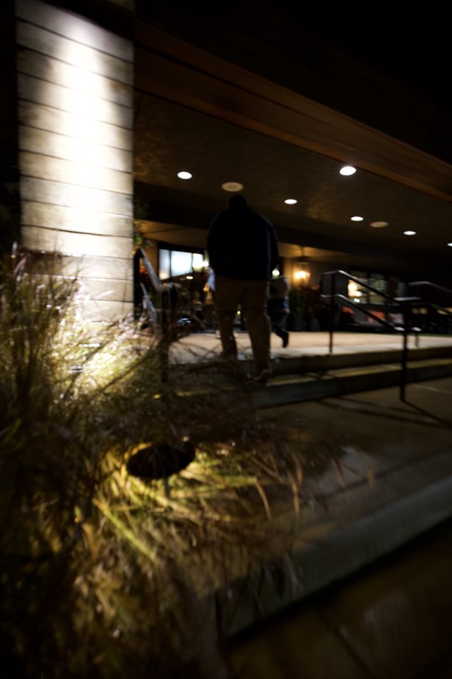 Modern Hotel Entrance at Night with Illuminated Landscape