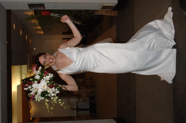 Triumphant Bride Raises Bouquet in Wedding Celebration