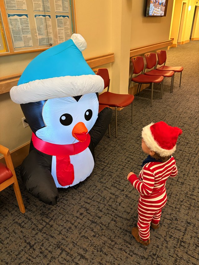 Toddler Meeting Inflatable Snowman at Holiday Event