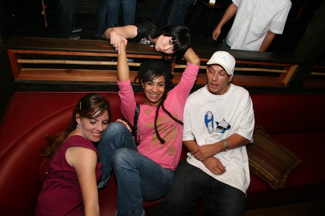 Friends Posing at a Nightclub Booth in 2005