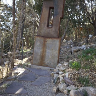 Rusted Metal Sculpture in Wooded Garden Setting
