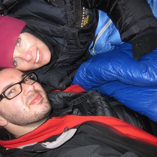 Bundled Up Friends Sharing Warmth on Cold Night