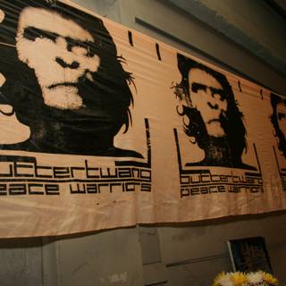Four Ape Faces on a Banner