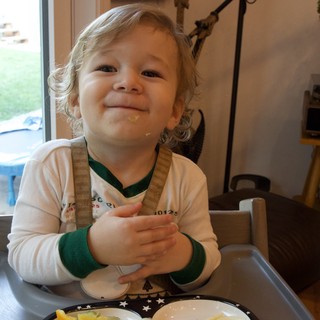 Joyful Toddler Enjoying Christmas Eve Meal at Home