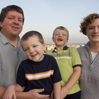 Happy Family Portrait on City Rooftop at Dusk