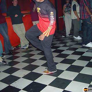 Red-shirted man getting his groove on at a nightclub
