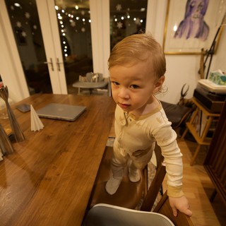 Curious Toddler at Wooden Dining Table in Modern Home