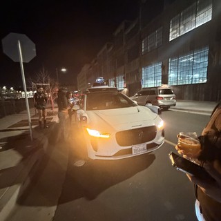 White Sedan on Urban Street at Night