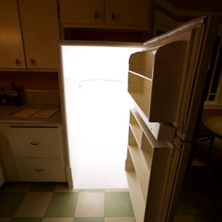 Bright Light Spilling from Open Refrigerator in Kitchen