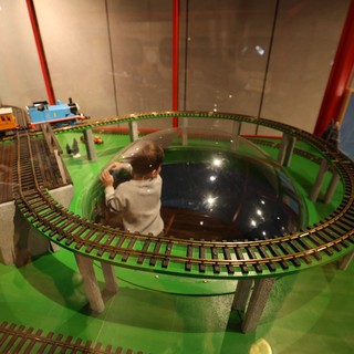 Child Operating Model Train Set at Interactive Museum Display