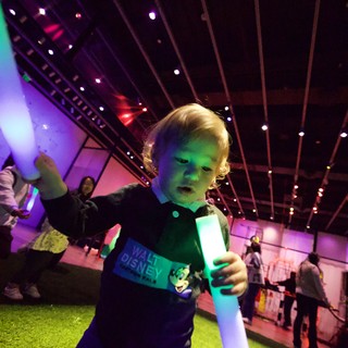 Young Child with Light Saber at Baby Rave Event