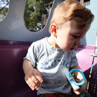 Young Child Playing at Colorful Playground Equipment