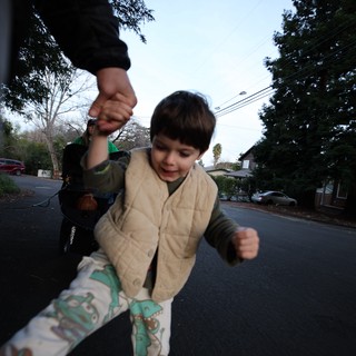 Child's Joyful Stride on Suburban Evening Walk