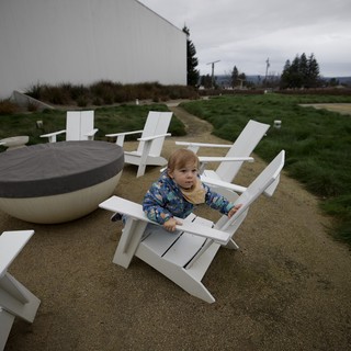 Toddler Relaxing in Adirondack Chair on Cloudy Day
