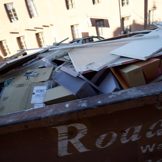 Overflowing Recycling Dumpster in Historic Urban Setting