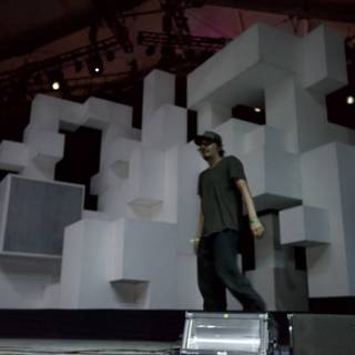 Man on Stage with Cube Backdrop
