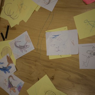 Children's Reptile Drawing Collection Scattered on Wooden Table