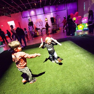 Children Playing with Light Sticks at Baby Rave Event