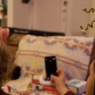 Children Capturing Christmas Morning Memories with Phone