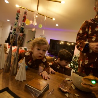 Children in Festive Pajamas at Christmas Table