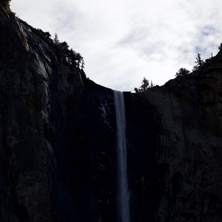 Waterfall Through Shadowed Granite Cliffs in Yosemite