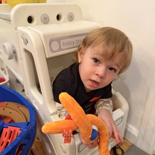 Toddler Playing in White Toy Truck