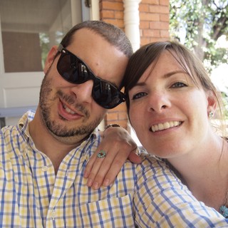 Smiling Couple Poses Together on Sunny Porch