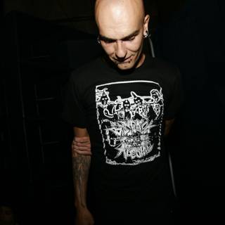 Bald man with tattoo and black T-shirt