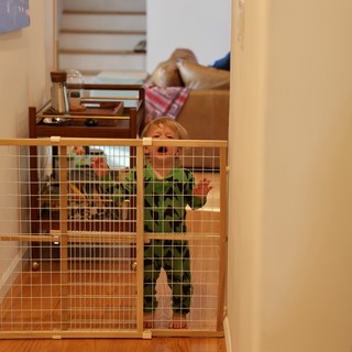 Toddler Behind Safety Gate in Home Interior