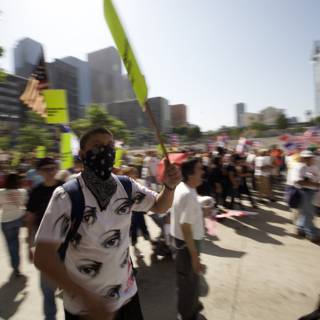Mayday Protester Holds Flag and Mask