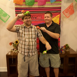 Two Friends Celebrate with Maracas at Fiesta Party
