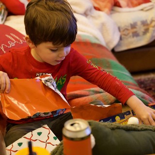 Young Boy Unwrapping Christmas Presents on Christmas Morning