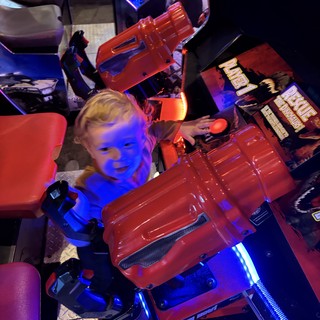 Child Playing Racing Game at Arcade