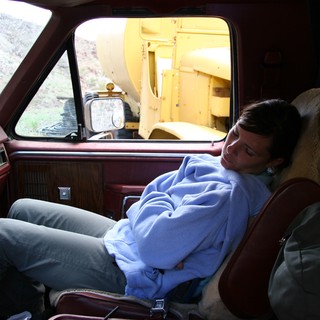 Weary Traveler Napping in a Vintage Truck Cab