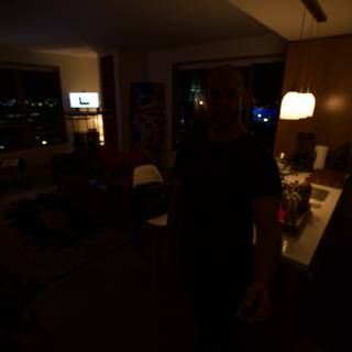 Man in Dark Living Room