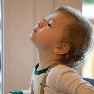 Young Child Gazing Upward in Wonder