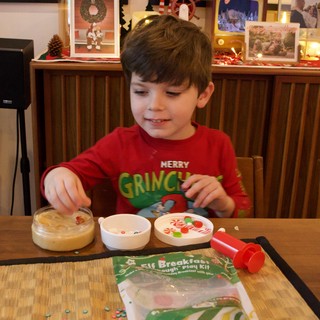Young Boy Making Christmas Grinch Play Dough Creation
