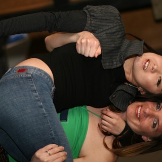 Two Friends Share a Playful Embrace at Event