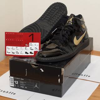 Black and Gold Sneakers on a Box