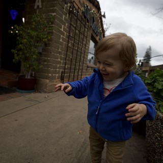 Toddler Exploring Urban Backyard on Cloudy Day