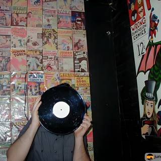 Record Enthusiast Surrounded by Comics