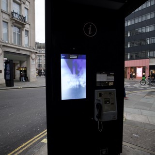 Modern Phone Booth with Digital Screen in London Street