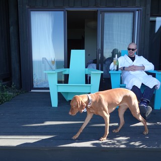 Relaxing with Dog on Modern Deck
