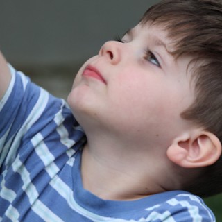 Young Boy Gazing Upward in Peaceful Contemplation