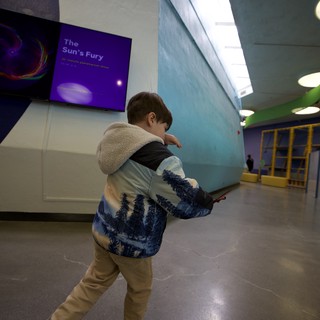 Young Boy Explores Museum with Winter Nature Jacket
