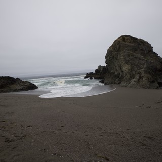 Moody Coastal Rock Formation on Foggy California Beach