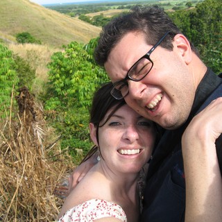Joyful Couple Embracing on a Scenic Hillside